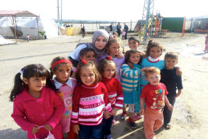 Researcher Aala El-Khani with children living on the refugee camp in Qah, Syria