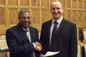 Dr Krishna Persaud getting his award from Prof Colin Hughes