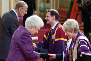 The President receiving the award from the Queen