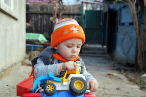 child playing with toy car