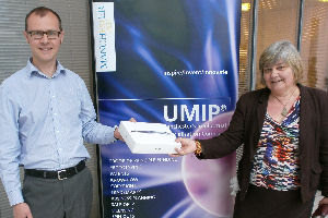 Dr Ed Maughfling presents competition winner Dr Ursel Bangert with an iPad
