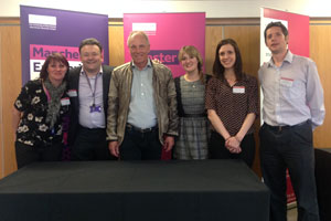 Five people stood in front of a table