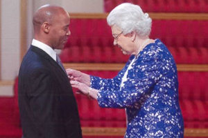 Lenox receives his OBE from the Queen