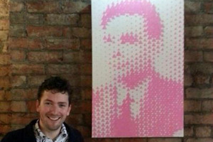 Conor Collins with his portrait of Alan Turing