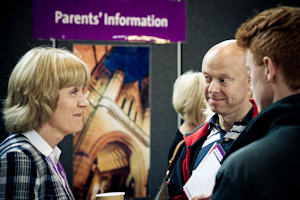 Volunteer talking to a parent at a previous Open Day