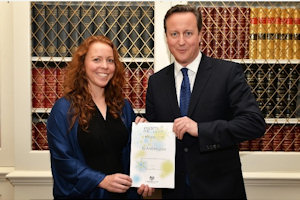 Dr Hughes receives her award from the Prime Minister