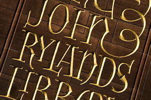 Words carved into wood saying: the John Rylands Library