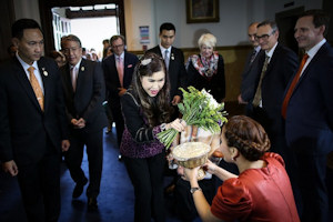 The Princess holding a bouquet as she greets members of staff 