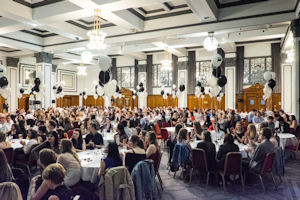 Everyone seated at dining tables for the clelbration 