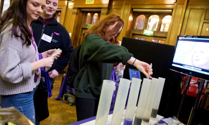 Technical apprentices cast votes at a discussion stand