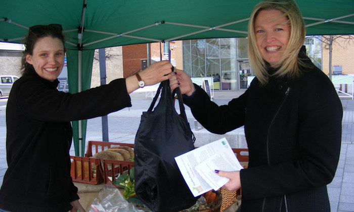 handing over a veg bag at the Veg Box People stall