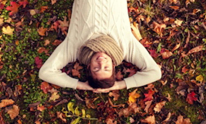 Woman lying in leaves