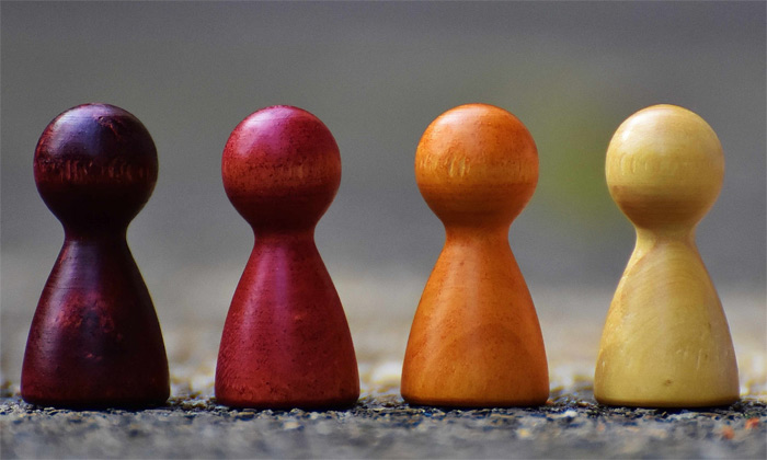 4 wooden board game playing pieces