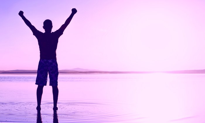 Man celebrating health on beach