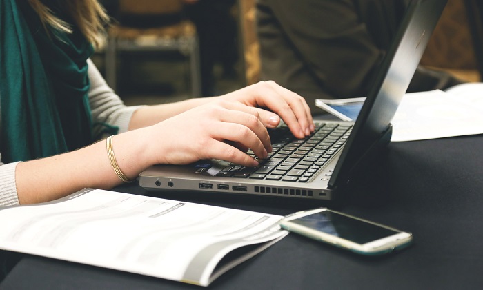 Woman typing on a laptop