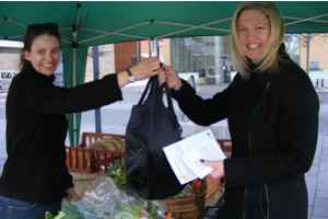 Customer collecting bag of veg from Veg Box People