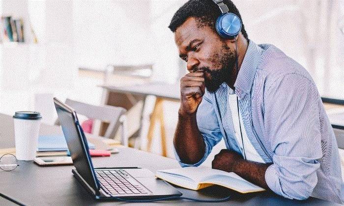 Student working on a laptop at home