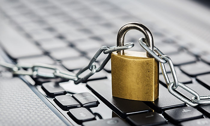A photograph of a padlock and chain on a computer keyboard