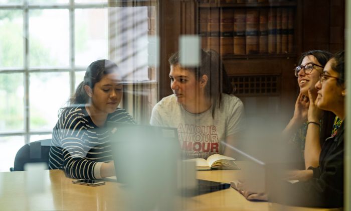 Student sat at desk with tablet