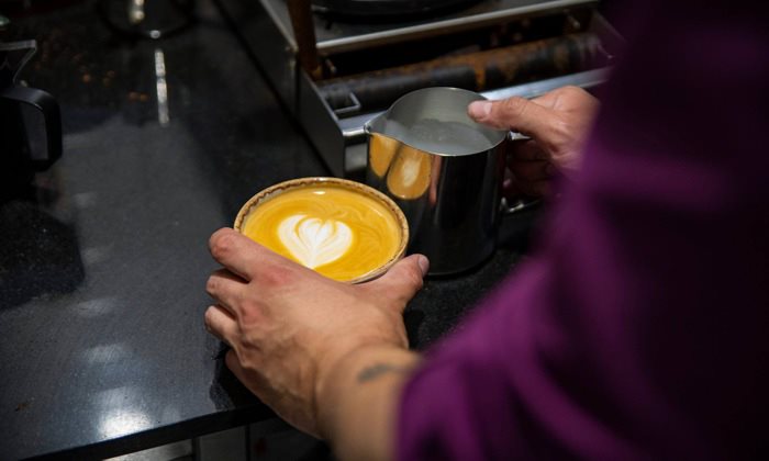 Person holding up of coffee