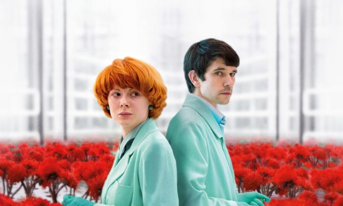 Two characters in turquoise suits stood in a film available on BFI Player