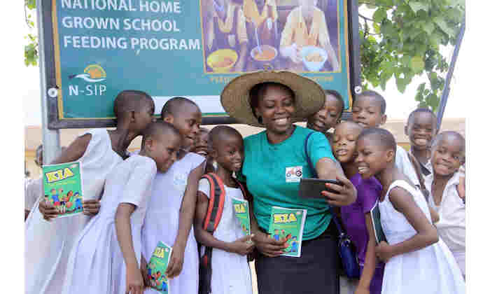 Rita Robert Otu and children from farming community