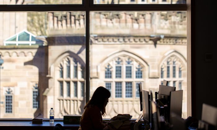 Silhouette of student working in AGLC in front of window