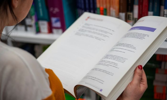 Close up of a book being held in Library