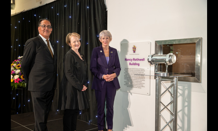 Nancy Rothwell, Philippa Hird and Nazir Afzal standing by a plaque of building