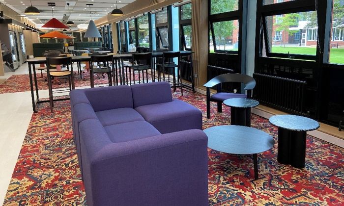 Interior of Ellen Wilkinson Commons showing bright space with tables and chairs