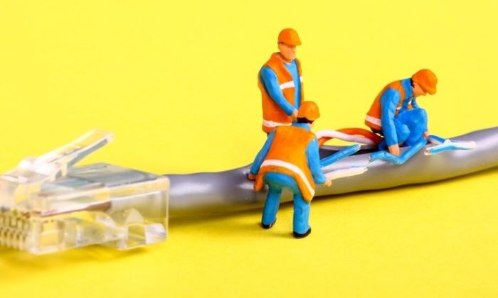 Toy mechanics positioned around a computer wire