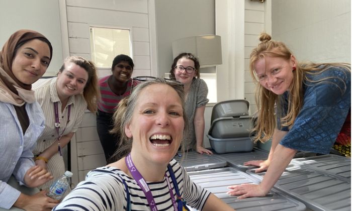 Colleague and student volunteers smiling in a selfie