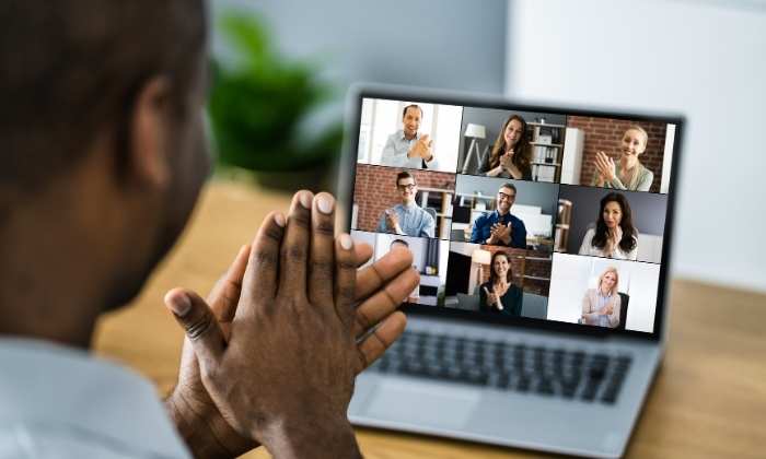 image of a person looking at a laptop in an online meeting