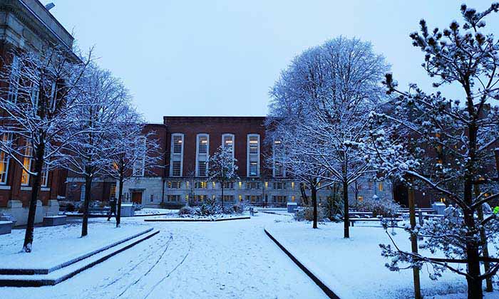Snow-covered courtyard outside the Main Library at The University of Manchester,