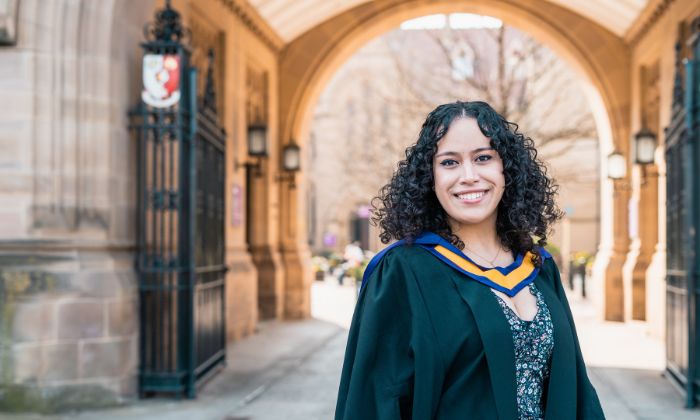 Graduating student under the arch