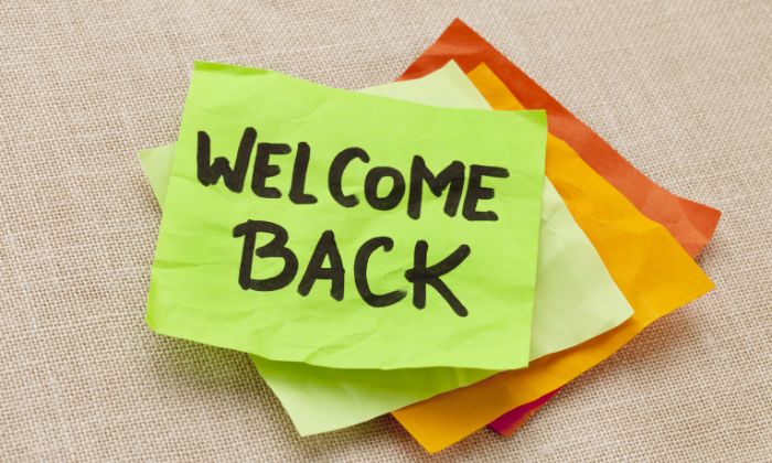 A post it note reading 'Welcome Back'