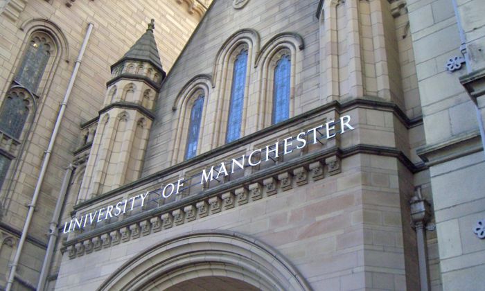 Old grand stone building with the words University of Manchester over an archway