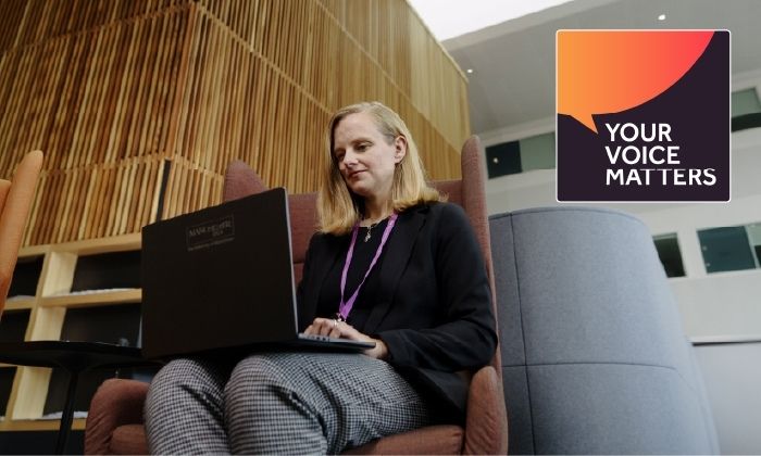 Woman sat working with a laptop on her knees