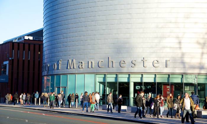 University building with people walking past on Oxford Road
