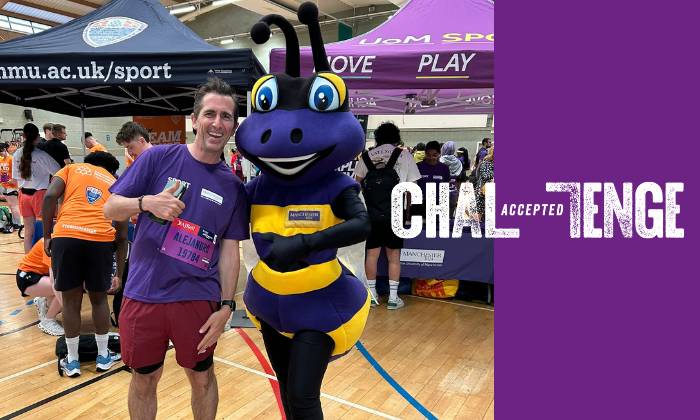 Smiling photo of Alejandro with the Bee mascot at last year's Purplewave