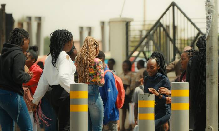Teenagers in Kenya standing in line for healthcare